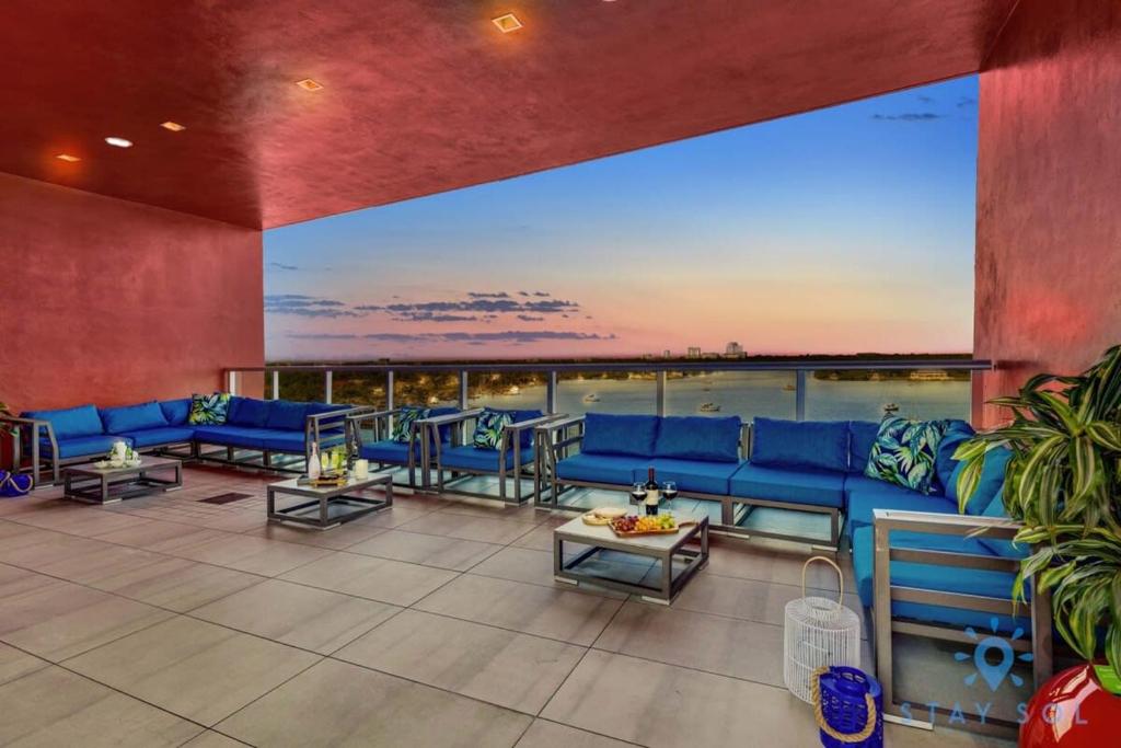 好莱坞Tropical Oasis - Rooftop Pool- Near Beach - Gym的大型客厅配有蓝色的沙发和桌子