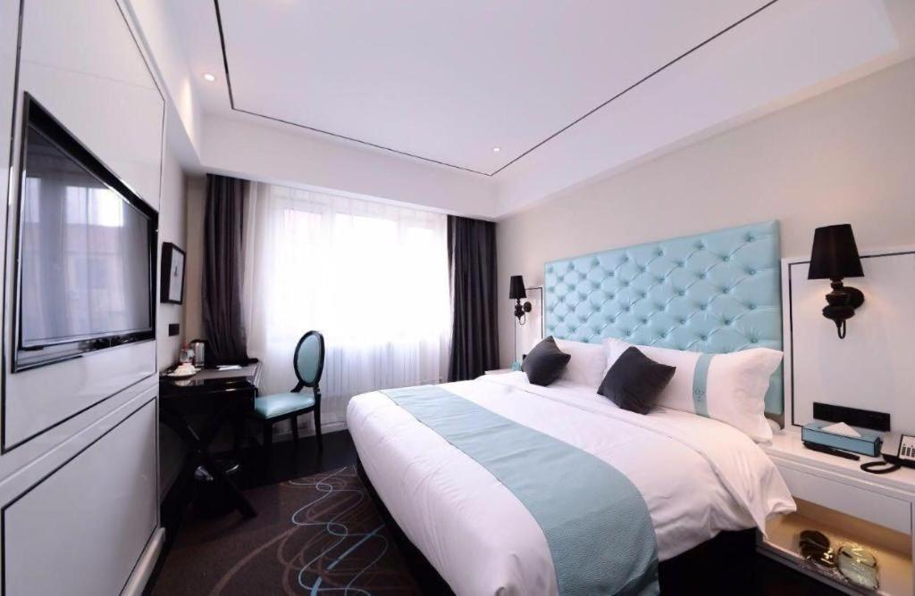 YufaXana Lite Hotel Beijing Daxing International Airport的酒店客房设有一张大床和一台电视。
