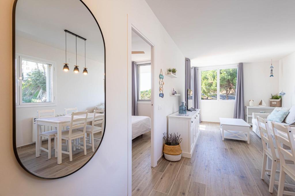滨海圣波尔Hauzify I Apartaments Can Pi的镜子反射着用餐室和客厅