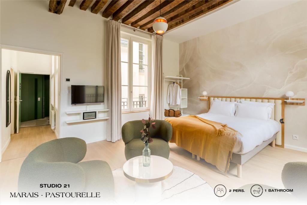 巴黎Beauquartier - Marais, Pastourelle的卧室配有一张床和一张桌子及椅子