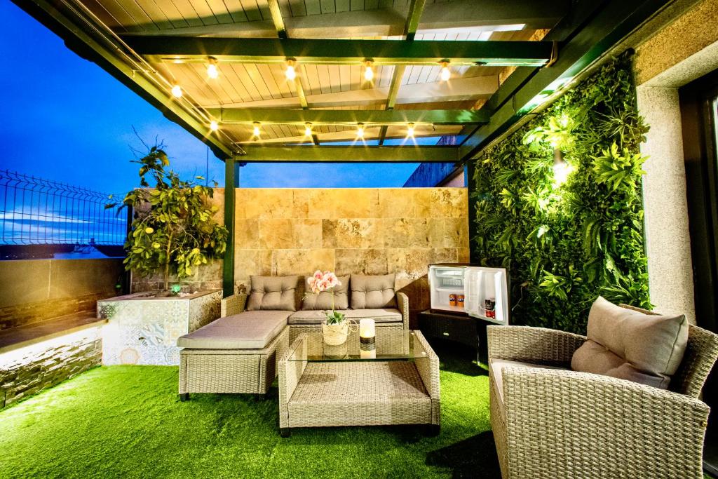 卢戈Lucus Skyline的一个带沙发和桌子的庭院,以及一些植物