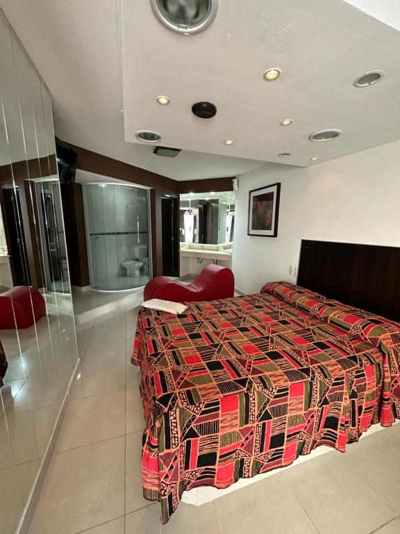 梅塞德斯镇Hotel venus的一间卧室配有一张大床和红色的被子