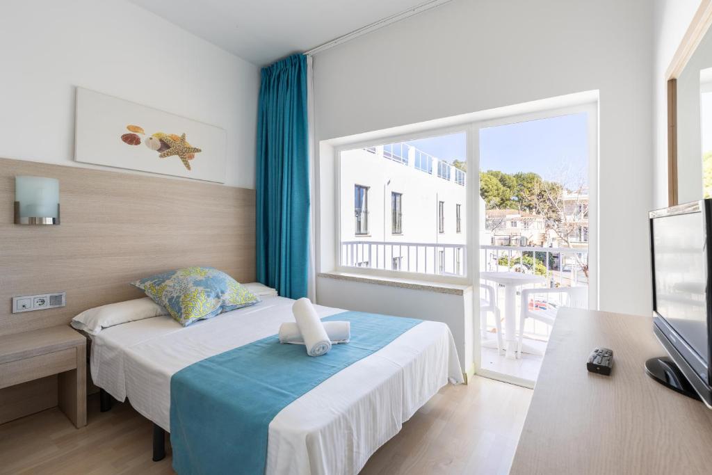 帕格拉海王星旅馆的一间卧室设有一张床和一个大窗户