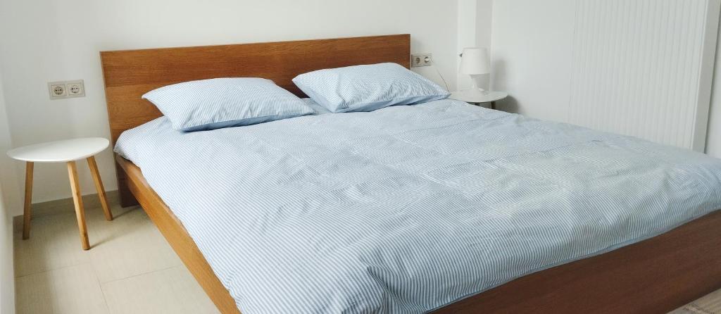 阿哈奈Lovely Place的卧室配有白色的床和木制床头板