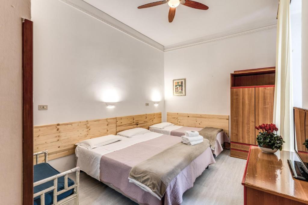 罗马阿尔塔维拉9号酒店的一间卧室配有两张床和吊扇
