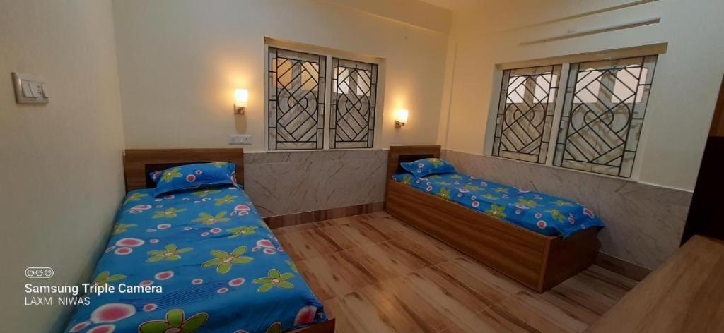 瓜廖尔Sengar's Inn的一间卧室设有两张床和两个窗户。