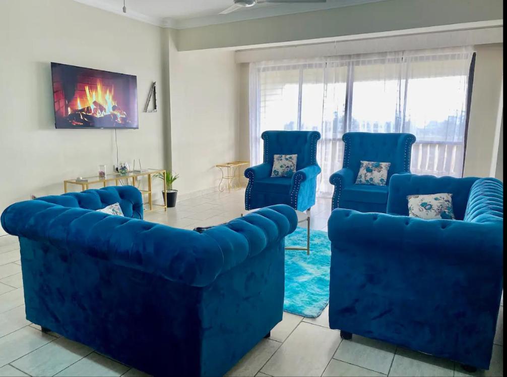 Ruirudeep east的客厅配有蓝色的沙发和桌子