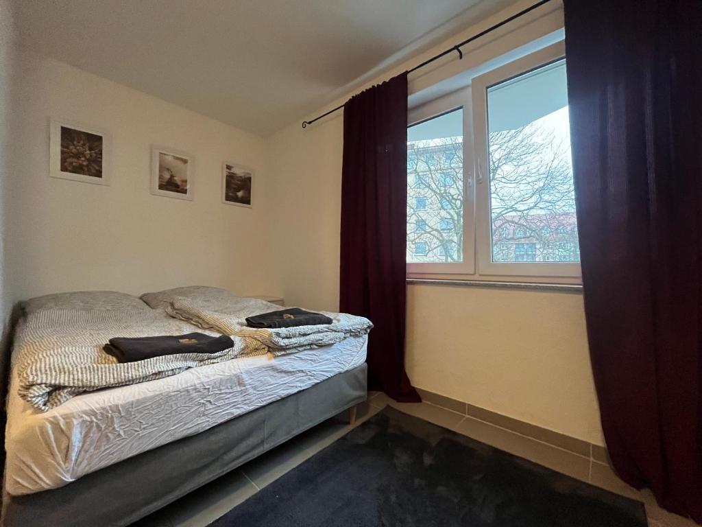 卡尔斯鲁厄Simplex Apartments Am Europaplatz的一间卧室设有一张床和一个窗口