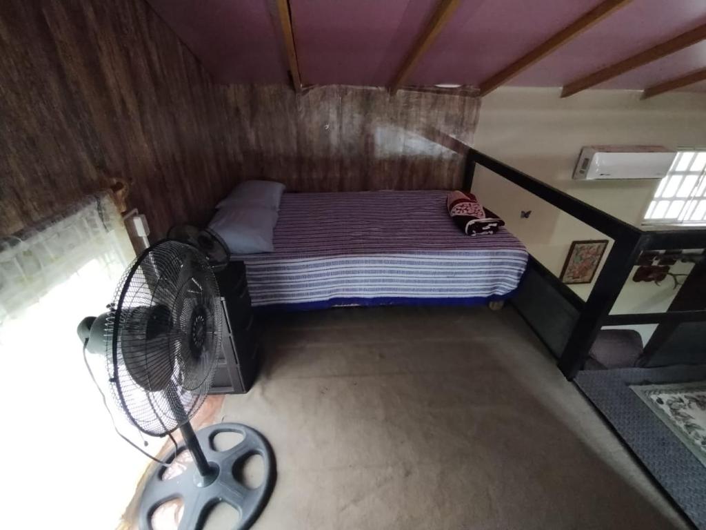 Gómez FaríasQuinta La Escondida的一间带一张床和风扇的小卧室