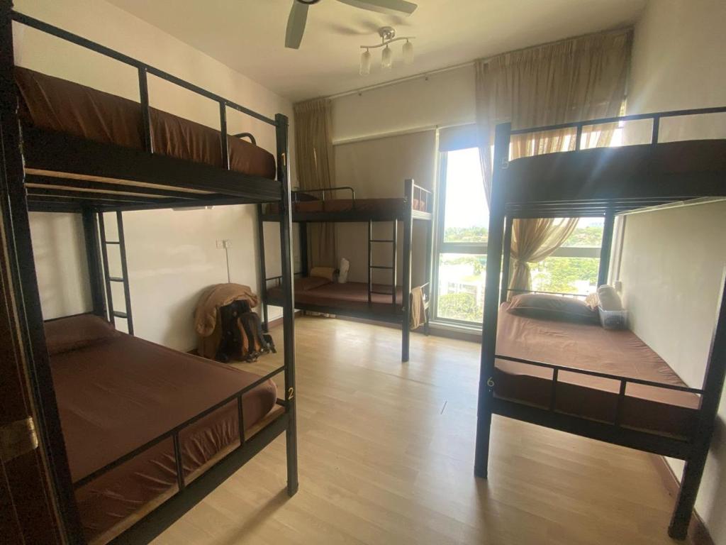 吉隆坡Regalia Exclusive Hostel的带三张双层床和走廊的客房