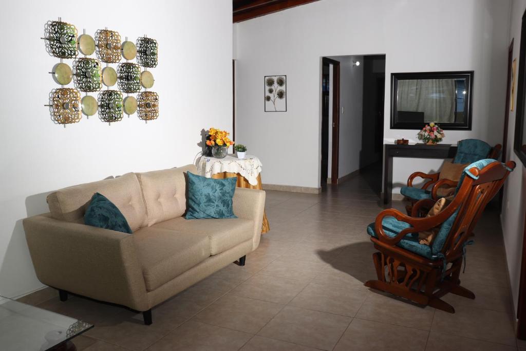 麦德林Medellin My Home的客厅配有沙发和椅子