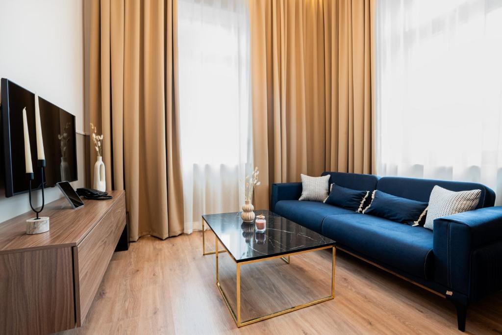 卡瓦拉Oikia Classic House的客厅配有蓝色的沙发和电视