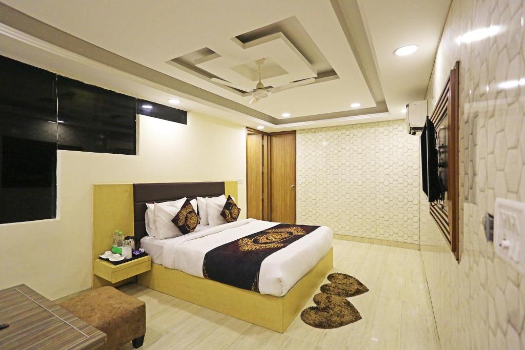 新德里Hotel Grand Suites By D Capitol- New Delhi Airport的一间卧室配有一张床和一台电视。