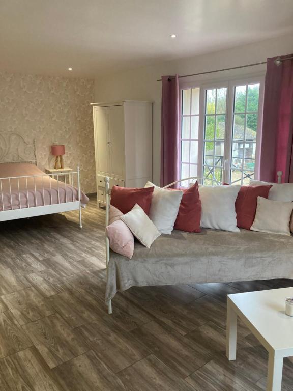 Amfreville-sur-Iton洛瑞雅德公寓的客厅配有沙发和1张床
