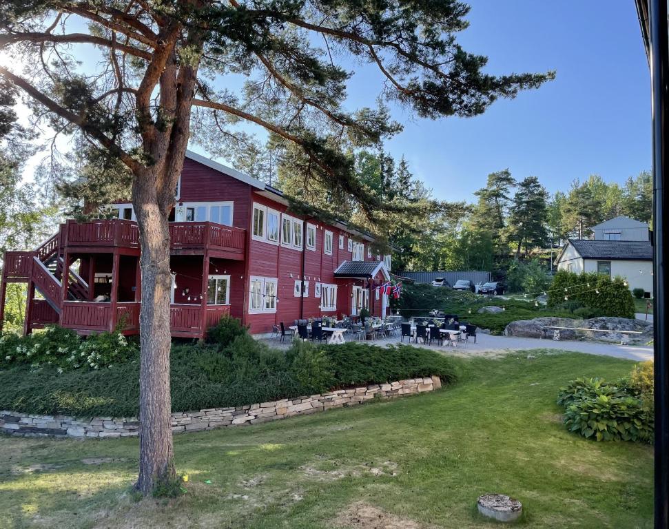 AkkerhaugenNorsjøtunet的前面有棵树的红色建筑