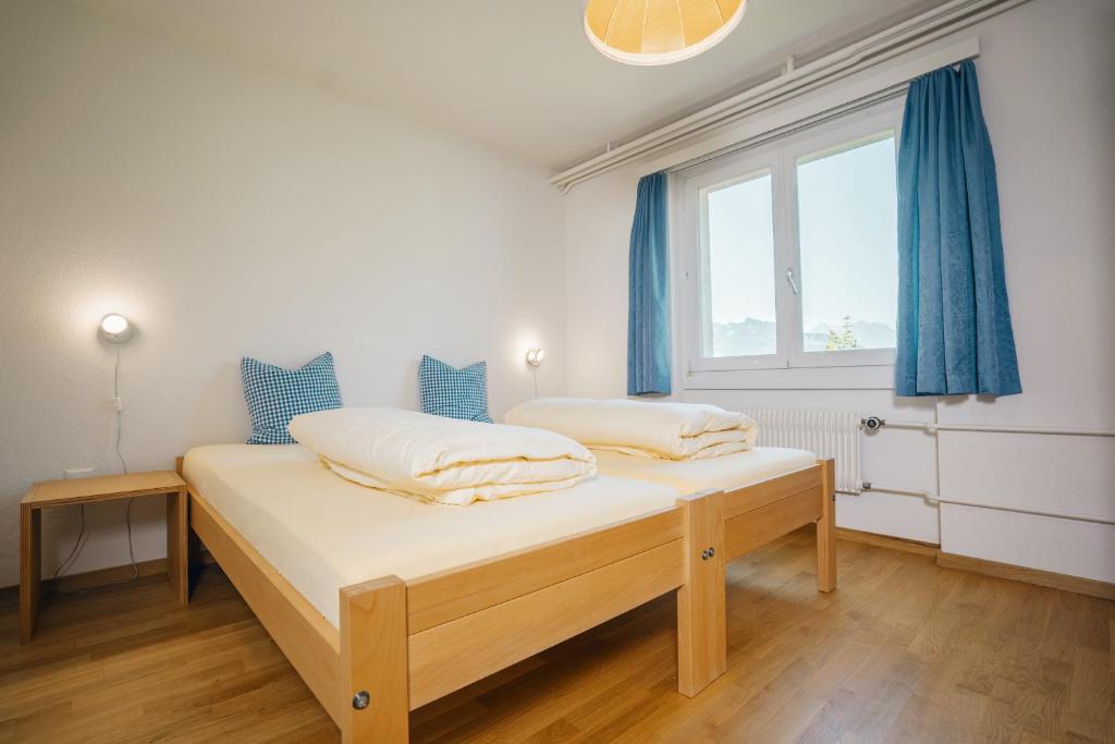 艾姆敦Schwendihaus Apartment的带窗户的客房内的两张床