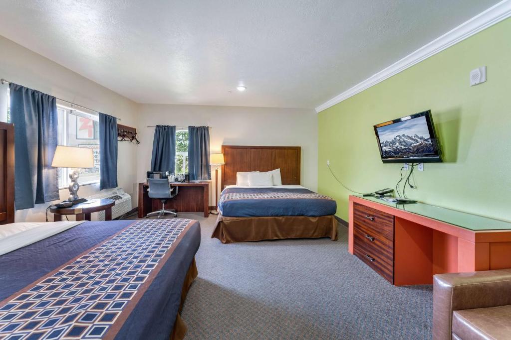 拉沃肯Ramada by Wyndham La Verkin Zion National Park的酒店客房设有两张床和电视。