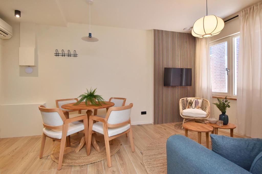 斯海弗宁恩Four Star Apartments - Keizerstraat的客厅设有餐桌和椅子