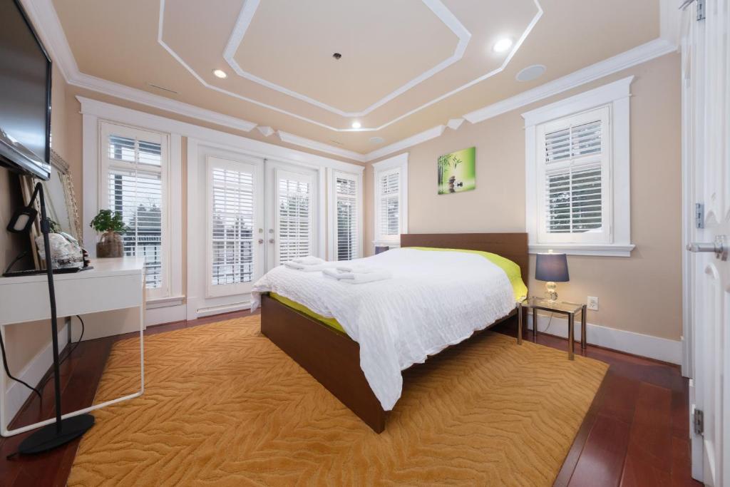 温哥华Oakridge Luxury Homestay的一间设有床铺的卧室,位于带窗户的房间内
