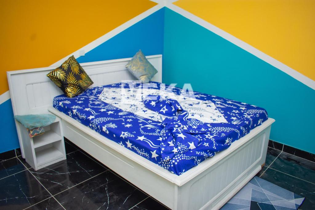 黑角Studio moderne的一张带蓝色和白色棉被和枕头的床