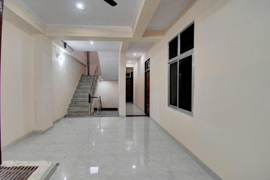 斋浦尔Shree Shyam Palace的一条带白色墙壁和楼梯的走廊