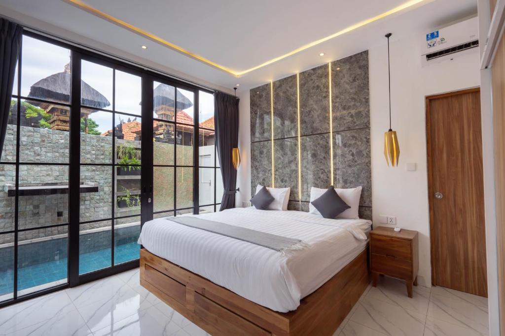 塞米亚克The Lavana Seminyak Loft 360 - 1 Bedroom Villa with Private Pool的一间卧室设有一张大床和大窗户