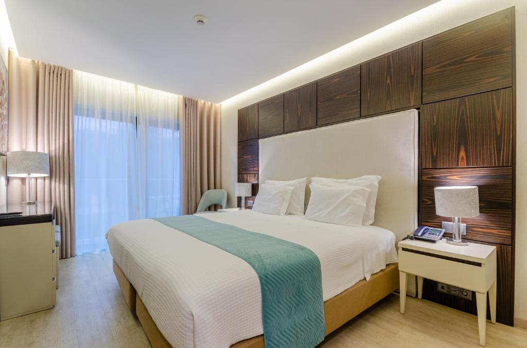 埃斯托利尔阿尔沃拉达酒店的酒店客房设有一张大床和一张书桌。