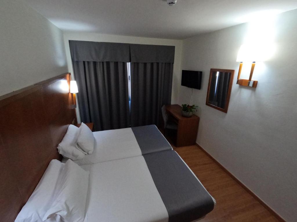 格拉纳达萨亚鲁酒店的酒店客房设有床和窗户。