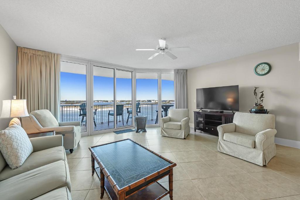 奥兰治比奇Caribe Resort Unit B603的客厅配有沙发、椅子和电视