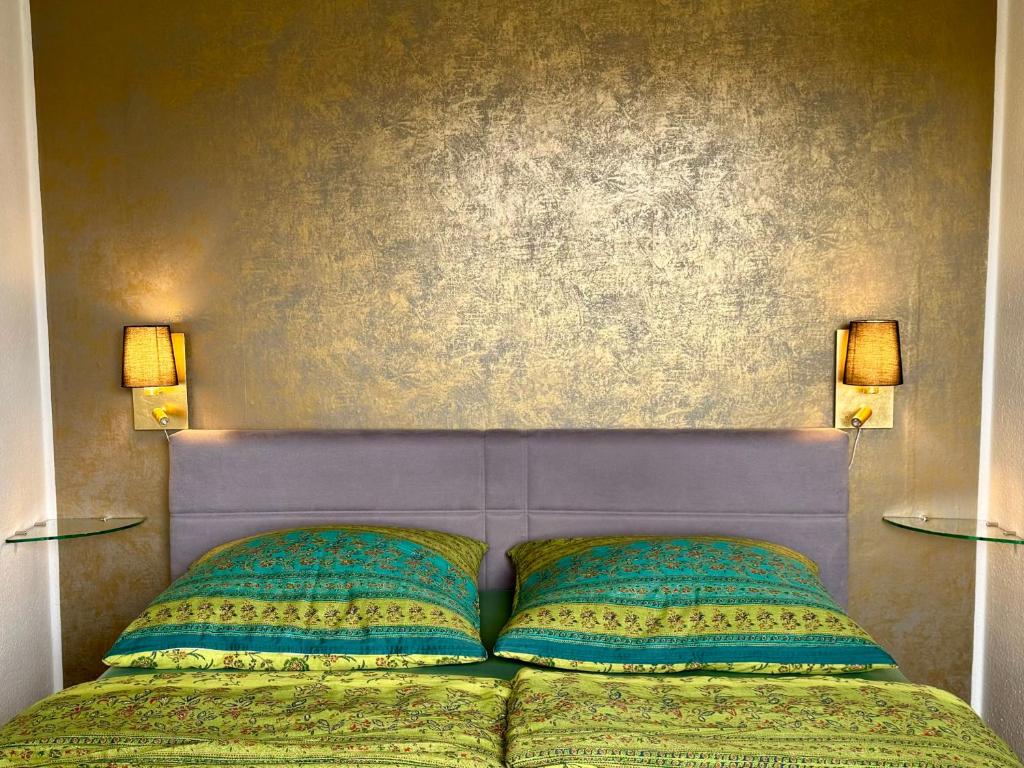 卡尔斯鲁厄AnNa Home & Sunny Home Apartments的一间卧室配有一张带两盏灯的床。