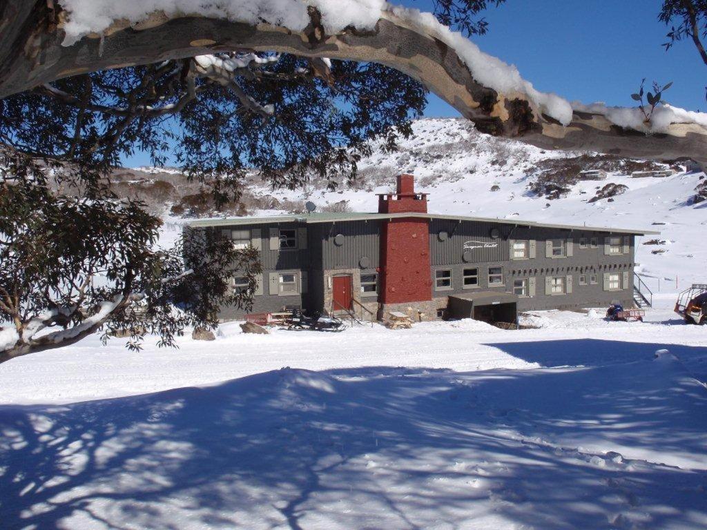 佩里舍峡谷流浪汉小屋酒店的建筑物前的雪地建筑