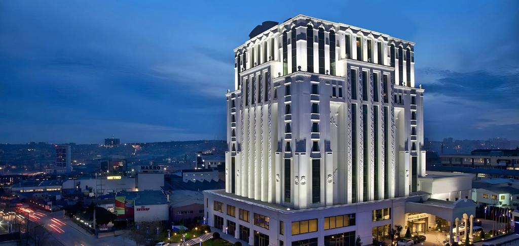 伊斯坦布尔Rotta Hotel Istanbul的一座高大的白色建筑,有很多窗户