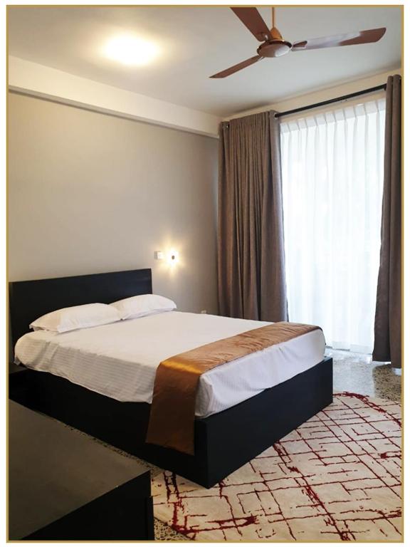 SerukeleOrange Guest Homes & Banquet Hall的一间卧室配有一张床和吊扇