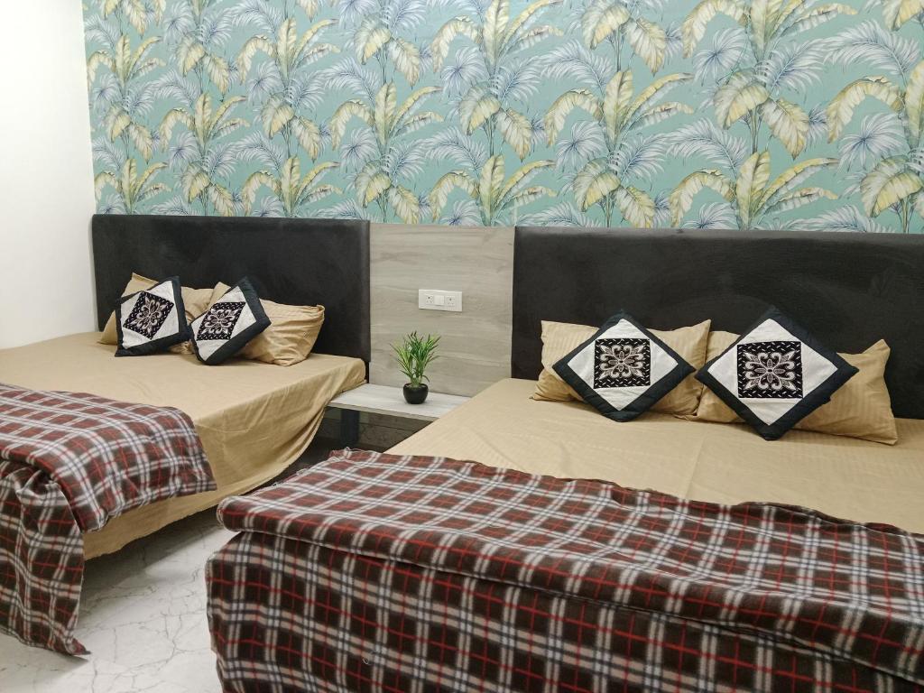 马图拉Hari Sharnam Home Stay的一张铺着铺着平底毯的房间里,有两张床