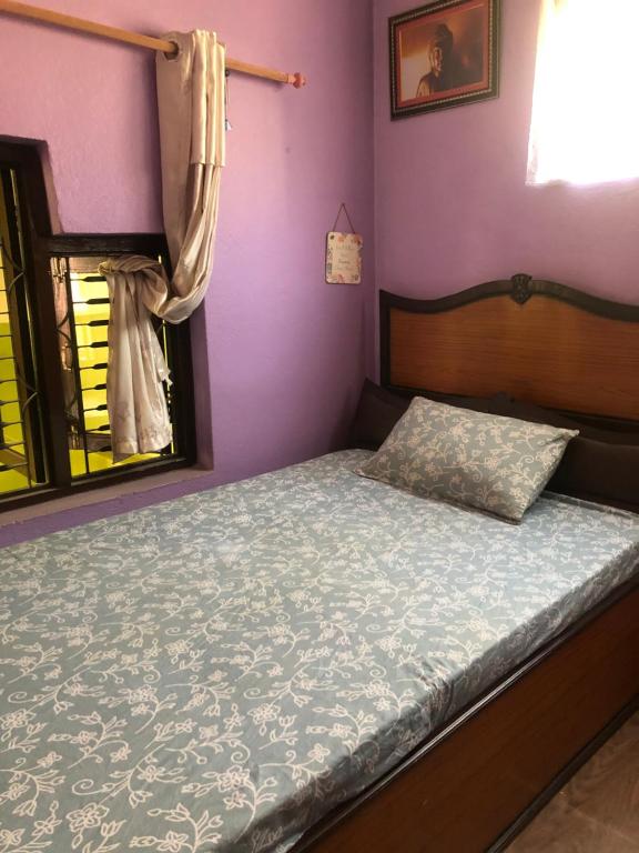 加德满都Diamond Home Stay - Private Rooms的一间卧室配有一张紫色墙壁和窗户的床