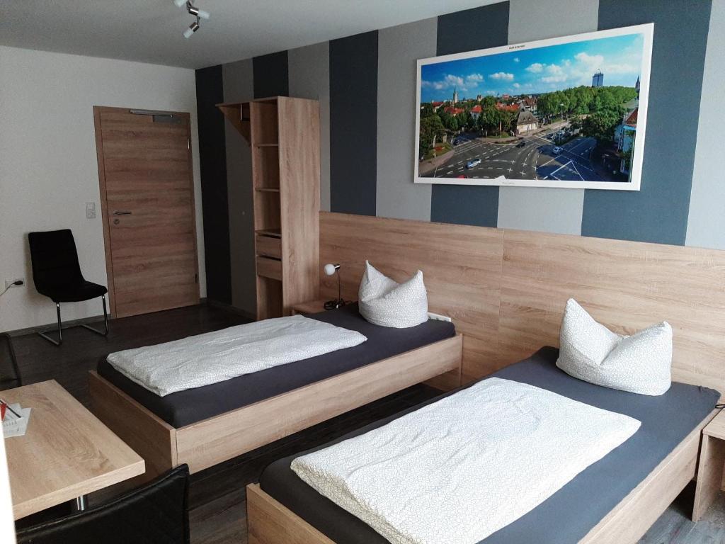 博尔兴Haus Roseneck-Pension Am Stadtrand的卧室配有两张床,墙上挂着一幅画