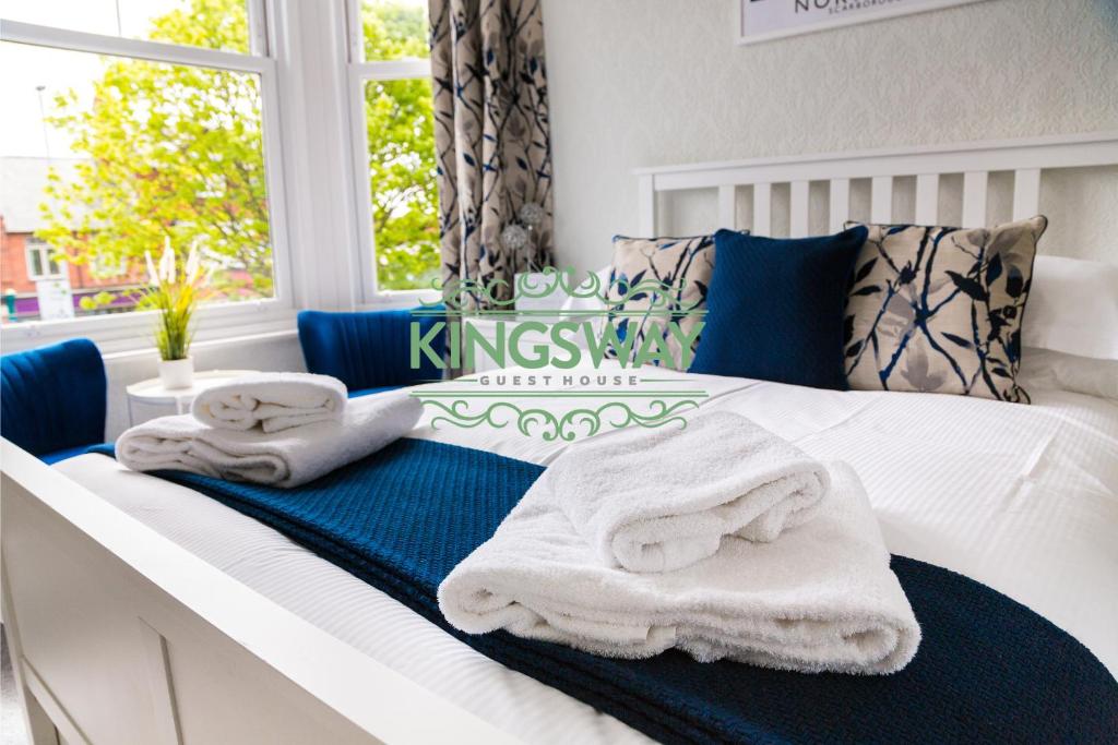 斯卡伯勒Kingsway Guesthouse - A selection of Single, Double and Family Rooms in a Central Location的卧室配有蓝色和白色的毛巾。