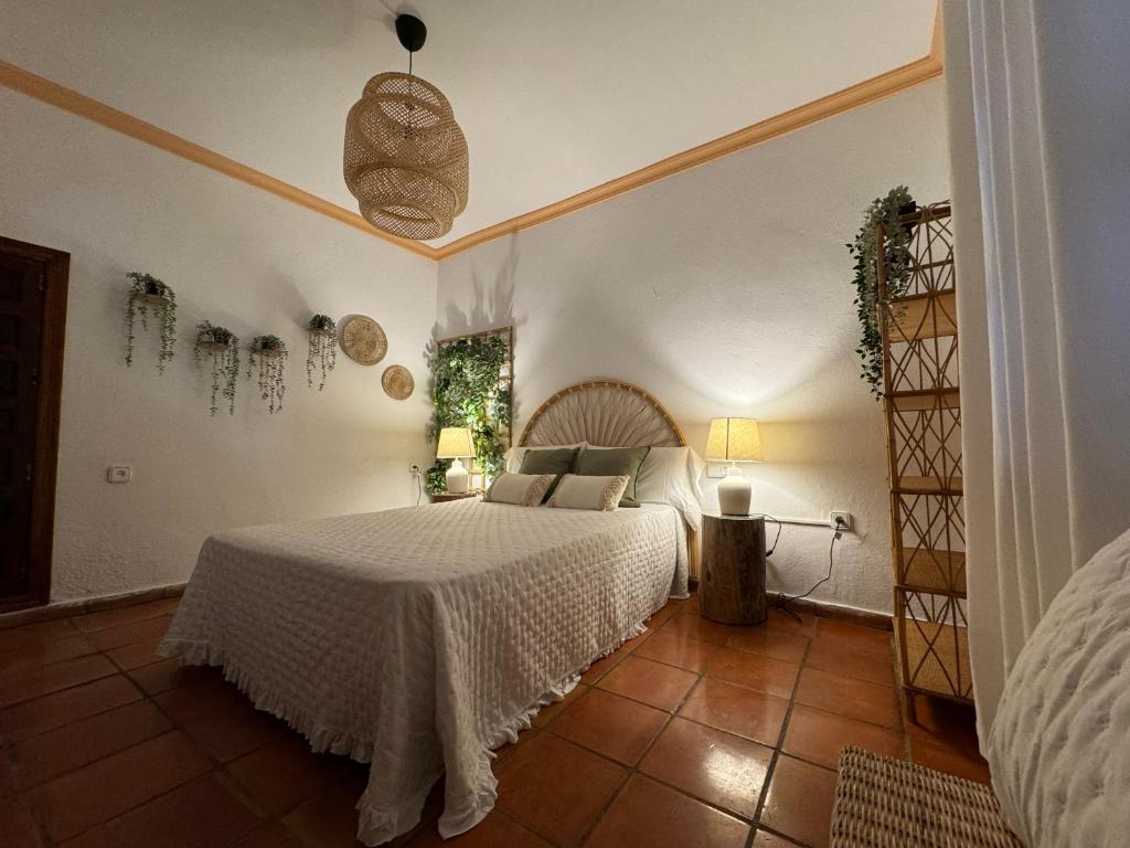 卡迪瓦Garden Suites Xativa的一间卧室配有一张带白色床罩的床