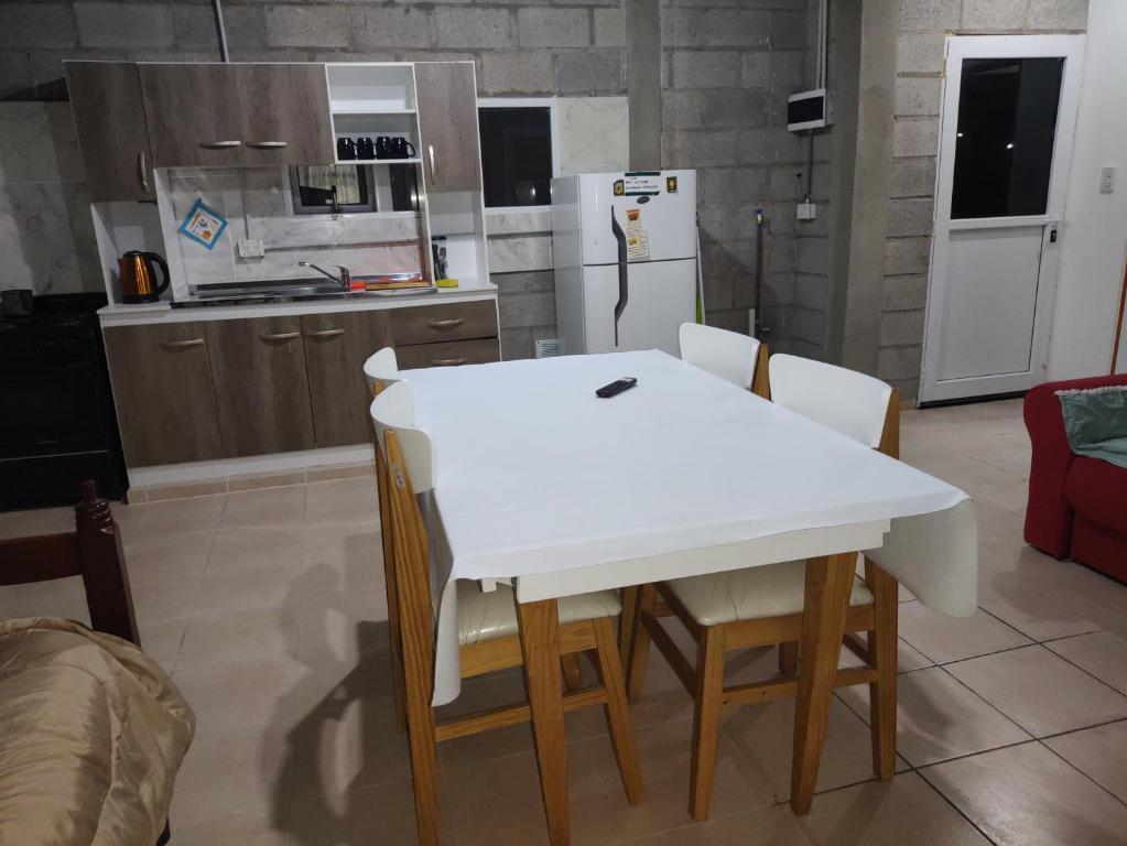 圣胡利安港Departamentos teuli的厨房配有白色的桌椅和冰箱