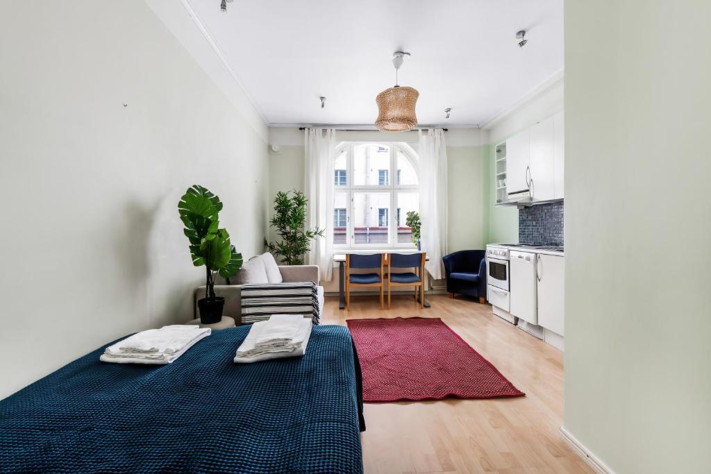 赫尔辛基Centrum - Lovely furnished Studio的一间带床和厨房的客厅