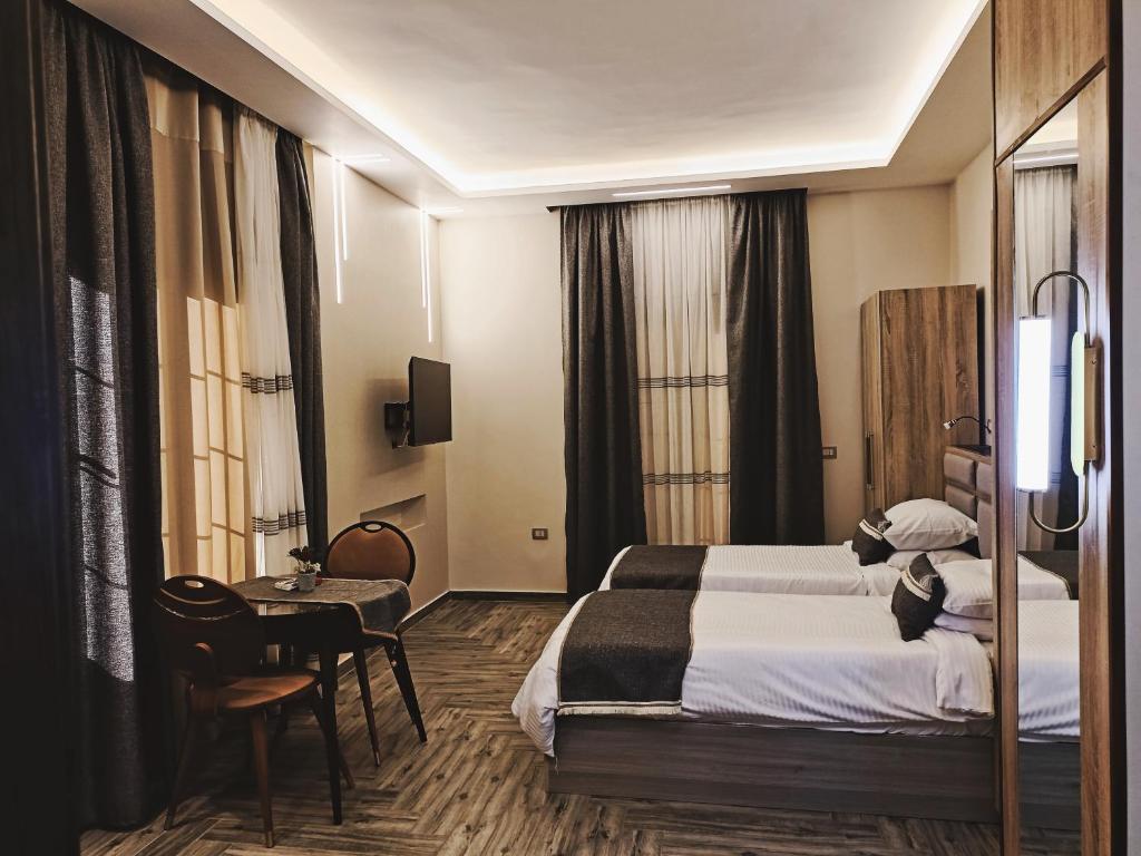 Sheikh ZayedRoyal Elegance Room的酒店客房设有两张床和一张桌子。