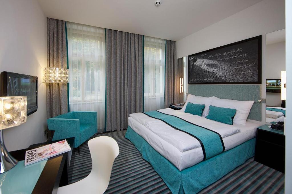 布拉格布拉格红与蓝设计酒店的酒店客房设有一张大床和一张书桌。