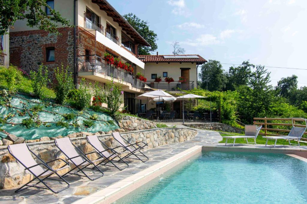QuagliuzzoCa Montiglio的一个带游泳池和椅子的度假胜地和一座建筑