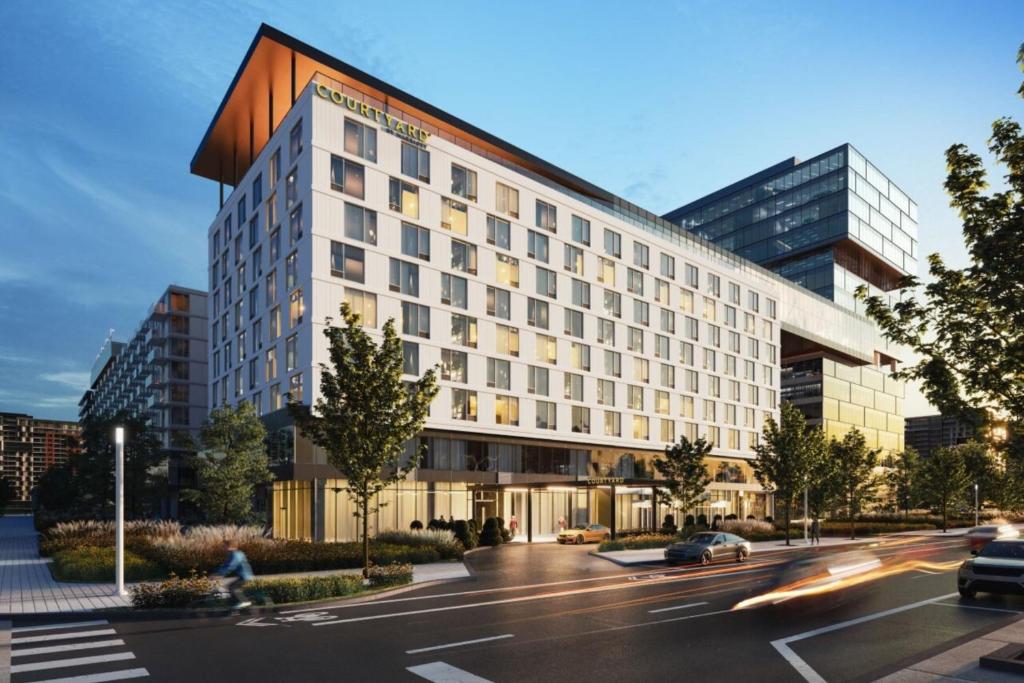 拉瓦尔Courtyard by Marriott Montreal Laval的街道上的建筑 ⁇ 染