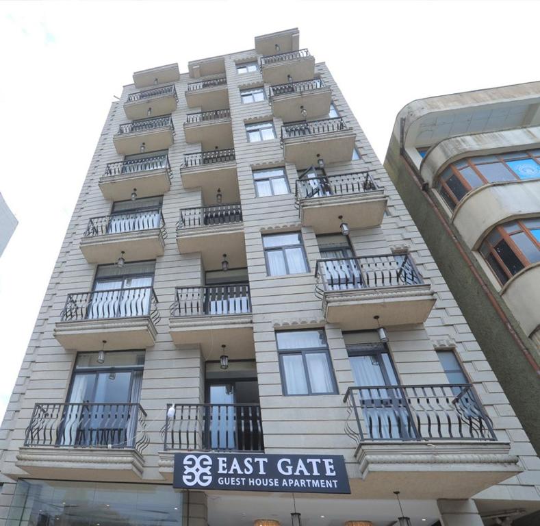 亚的斯亚贝巴East Gate Appartement Gust House的一座高大的建筑,旁边设有阳台