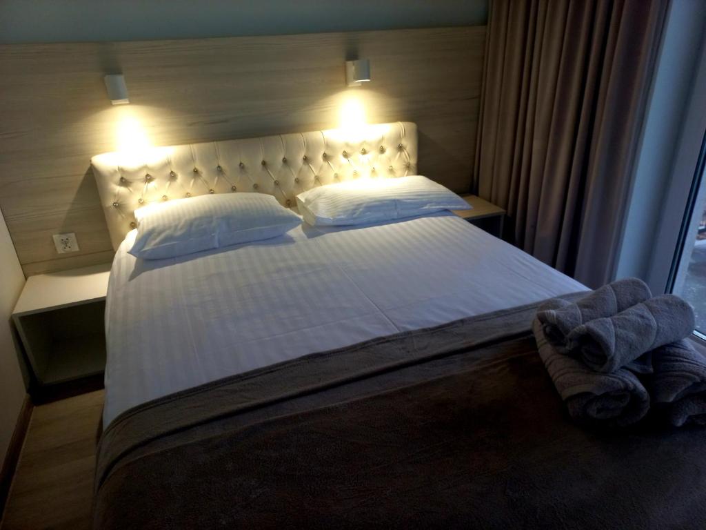 韦巴Apartament Sildatk的卧室配有一张带白色床单和枕头的大床。