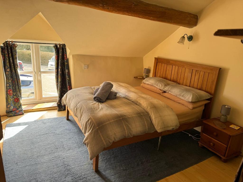 Llanrhaeadr-ym-MochnantAnnie’s Cottage的一间卧室设有一张床和一个窗口