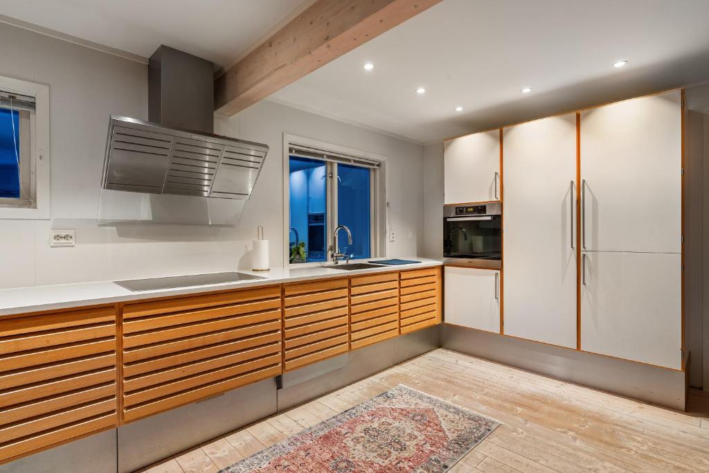 特罗姆瑟Villa Arctica的厨房配有木制橱柜和冰箱。
