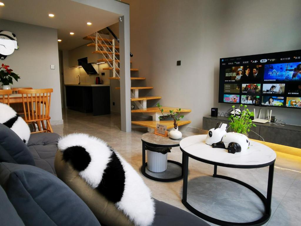 昆明Panda ZuoKe Besucher Apartment 熊猫坐客民宿的客厅里摆放着两只熊猫,躺在沙发上