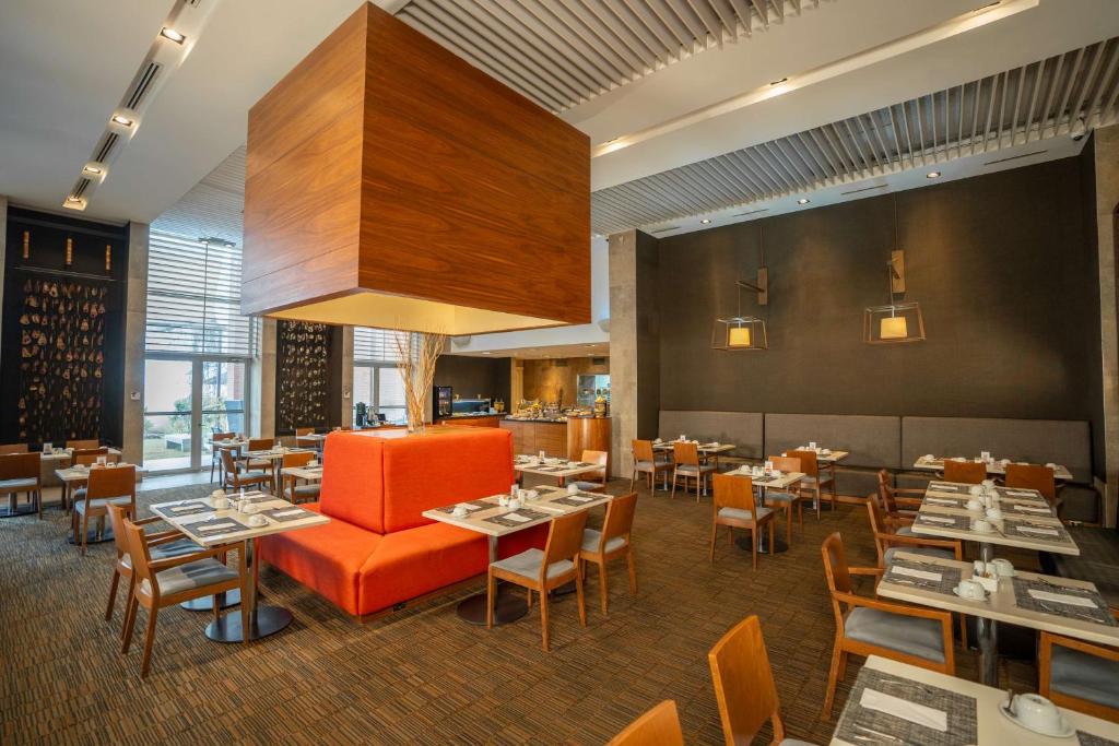 圣地亚哥圣地亚哥机场希尔顿花园酒店的用餐室配有桌椅